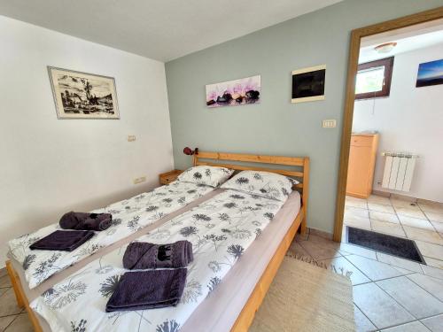 a bedroom with a bed with towels on it at Apartma Vučič in Bovec