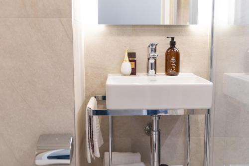 a bathroom with a white sink and a toilet at Appart Hotel Neostelia in Annecy