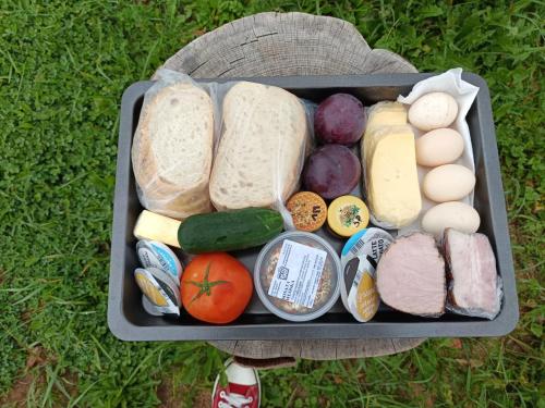 a tray filled with different types of food on the grass at Tatra Glamp Okrzeszyn - Siec noclegowa Tatra Glamp in Okrzeszyn