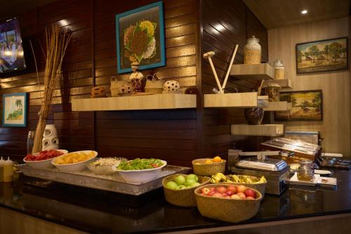 a buffet with bowls of fruits and vegetables on a counter at Eco Torarica in Paramaribo