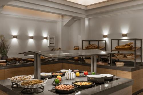 a bakery with many different types of food on a counter at Dolphin Bay Seaside Resort & Suites in Galissas