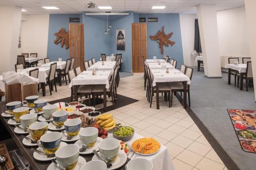 a dining room with tables with food on them at Hotel Metropol CB in České Budějovice