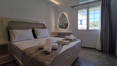 a bedroom with a large bed with towels on it at Marina's House in Kinídharos