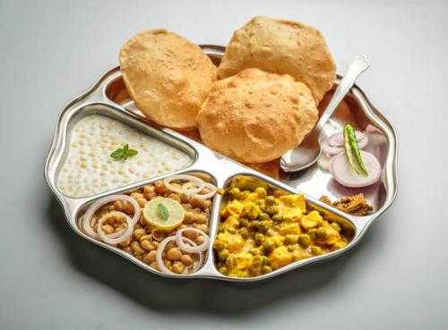 a lunch box with rice and different types of food at Glitz Hotels Priceless-Lokhandwala in Mumbai