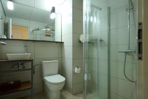 a bathroom with a toilet and a sink and a shower at Eco Torarica in Paramaribo