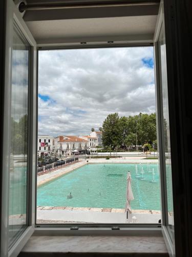 a view of a swimming pool from a window at Casas do Lago in Estremoz