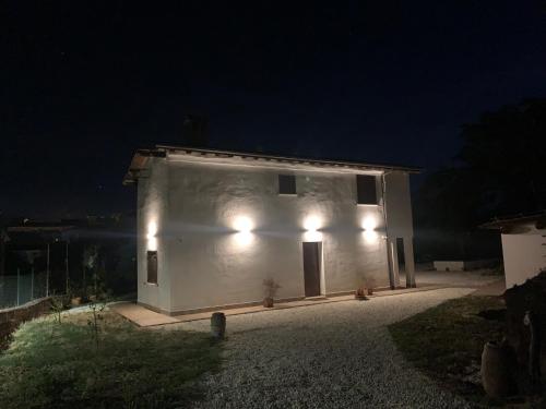 a small white building with lights on it at night at Domus Antonii in Corchiano