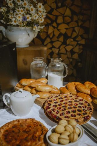 a table with bread and a teapot and a plate of food at Old Believers Apartment in Rēzekne