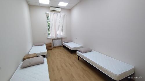 a room with two beds and a window at uaHOSTEL in Kyiv