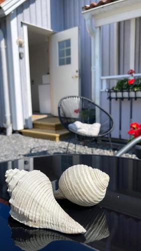 a hat sitting on a table in front of a house at Havssnäckan - Nordic Stay Strömstad in Strömstad