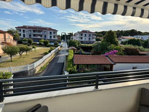 a balcony with a view of a street and buildings at Apartmani Gemma in Premantura