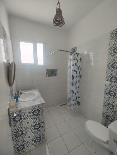 a bathroom with a sink and a toilet and a shower at Villa dar nina hergla in Hergla