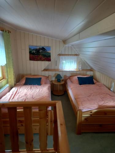 a room with two beds in a house at Kleinhohenfichten in Kurort Altenberg