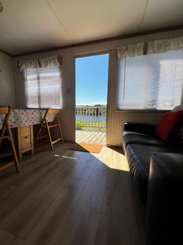 a living room with a couch and a view of the ocean at The Cranagh in Coleraine