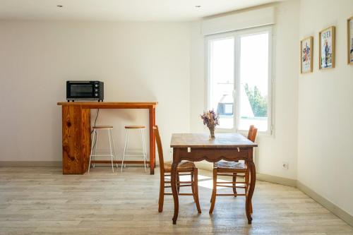 a dining room with a wooden table and chairs at La Casinière Coëtquidan in Guer