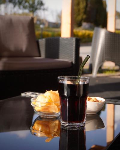 a drink sitting on a table with a bowl of food at Oasi Santa Rosa in Rome