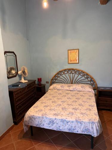 a bedroom with a bed and a dresser and a mirror at Azzurre BeB in Laterina