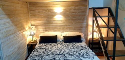 a bed in a room with a staircase and a room with a bed sidx sidx at La Salitella in Terracina