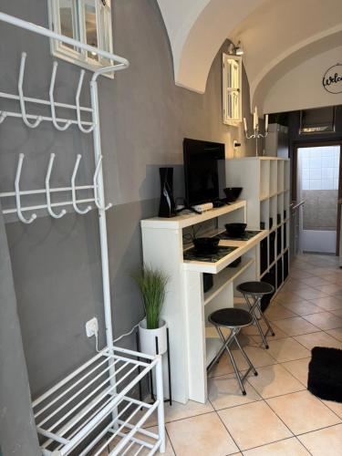 a room with a desk with a computer and chairs at Studio Old Town in Maribor