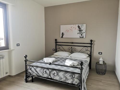 a bedroom with a black bed with two pillows at B&B Scirocco e Tramontana in Gallipoli
