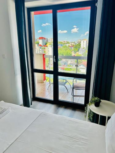 a room with a bed and a window with a view at Iulius Mall New Residence in Iaşi