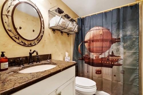 a bathroom with a sink and a toilet and a shower at Chic Loft | Downtown | Front & Market in Wilmington