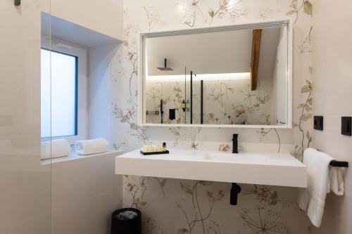 a bathroom with a sink and a mirror at Pardavila 57 Slow Hotel in Marín