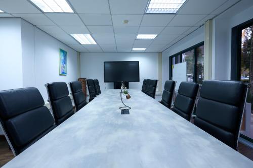 a conference room with a long table and chairs at Royal Torarica in Paramaribo
