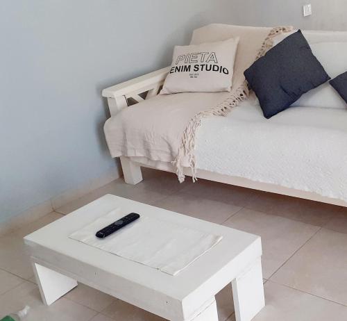 a remote control sitting on a table next to a couch at Victoria casa temporario in Santo Tomé