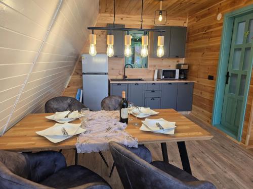 a dining room with a wooden table and chairs at Api Aframe in Avrig