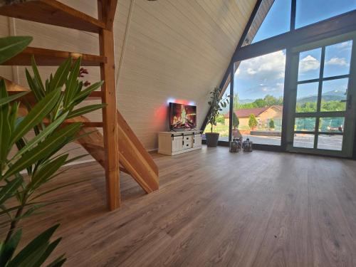 a living room with a staircase and a tv in a building at Api Aframe in Avrig