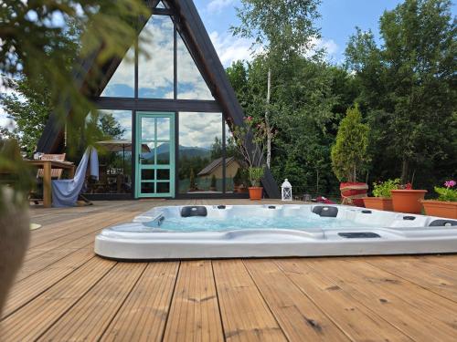 a jacuzzi tub on a wooden deck at Api Aframe in Avrig