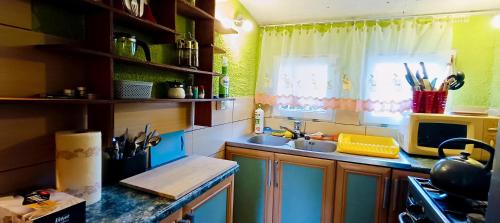 a small kitchen with a sink and a window at Domek Letniskowy nad jeziorem Głuszyńskim in Piotrków Kujawski