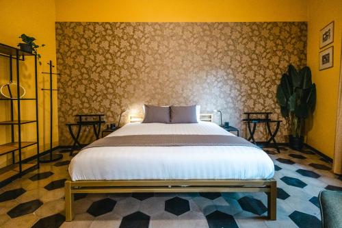 a bedroom with a bed and a wall at Casa Victoria in Spigno Monferrato