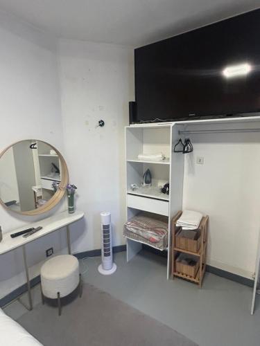 a bedroom with a desk and a mirror and a bed at 3 communes in Montreuil