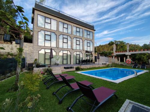 a house with a swimming pool in the yard at Sequeira Arantes Casa 2 in Terras de Bouro