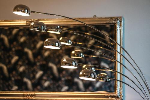 a lamp in front of a mirror with a picture at Casa Victoria in Spigno Monferrato