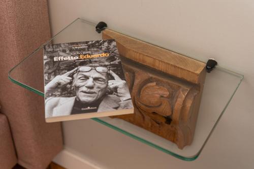 a magazine in a glass box on a wall at Deluxe Spaccanapoli in Naples