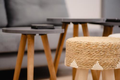 a pair of end tables and a stool in a room at Coastal Bliss- Tsoutsouros in Tsoútsouros