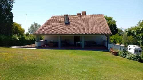 a house with a large lawn in front of it at Appartamenti Villa Abbraccio in Siena