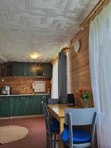a kitchen and dining room with a table and chairs at Marija in Krāslava