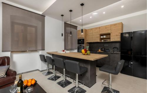 a kitchen with a large island with black appliances at 4 Bedroom Stunning Home In Crikvenica in Crikvenica