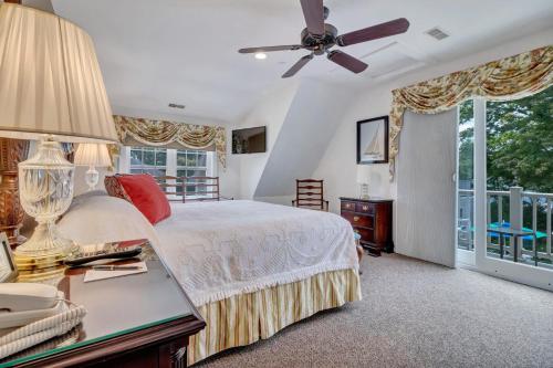 a bedroom with a bed and a ceiling fan at The Winstead Inn in Harwich