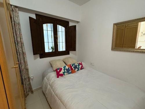 a small bed in a room with a window at Ideal pool Bungalow HMWY in Torrevieja