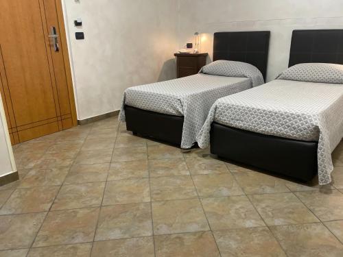 Ένα ή περισσότερα κρεβάτια σε δωμάτιο στο Hotel Toscano