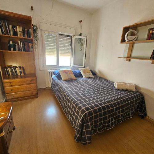 a bedroom with a bed with a checkered blanket at Casa Rural "AMARA" Bardenas in Valtierra