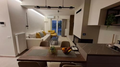 a kitchen and living room with a table and a couch at Modern luxury apartments in Evia in Chalkida