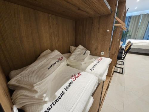 a bed in a room with towels on it at ApartHotel Rahl 24h Self Check-in in Hamburg