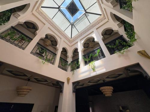 a building with a ceiling with potted plants at Riad Perles d'Annellia in Marrakech