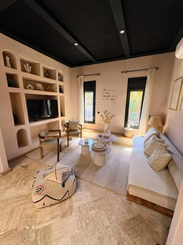 a living room with a couch and a table at Riad Perles d'Annellia in Marrakech